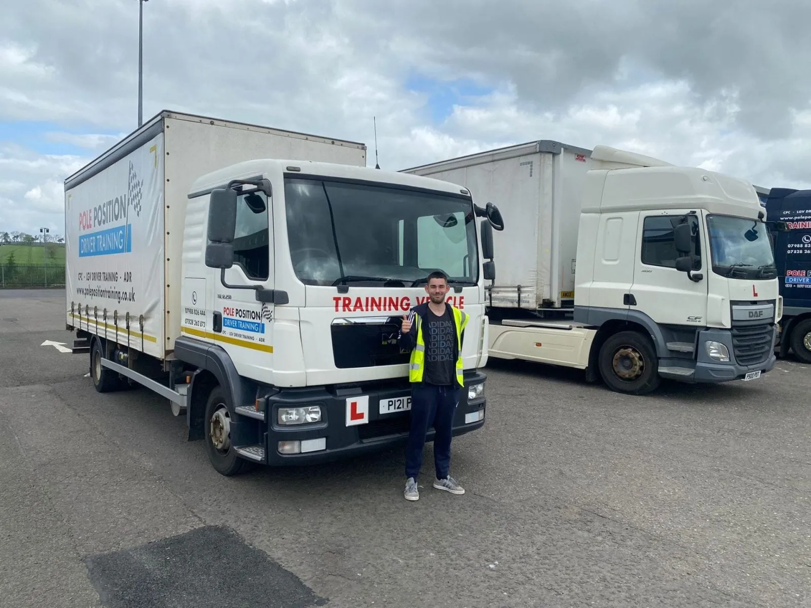 Driver beside rigid lorries used for Category C training Pole Position Livingston